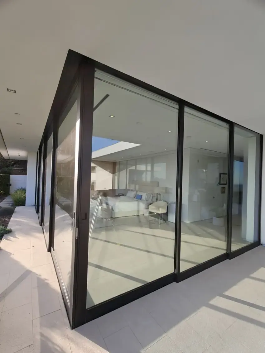 Fleetwood corner sliding door in dark bronze after service and glass replacement in a Los Angeles hillside home