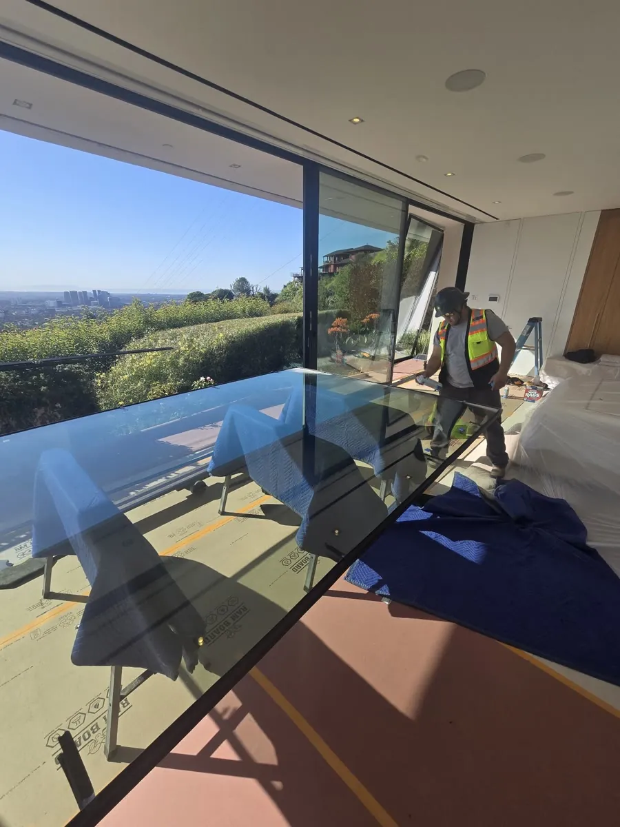 Replacement insulated glass panel being cleaned and prepped for a Fleetwood sliding door during a Versa Glass Co. service call in Los Angeles