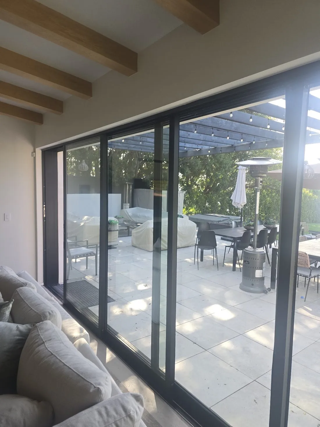 Fleetwood multi-slide doors opening a living room to a patio, installed by Versa Glass Co.