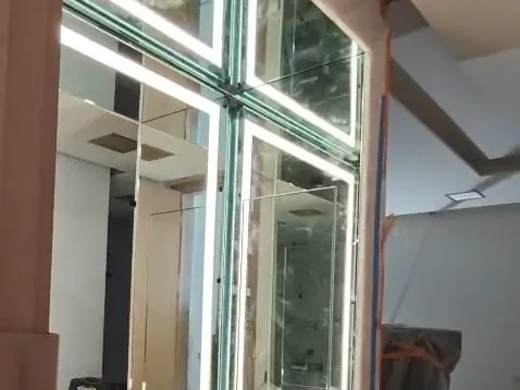 Backlit LED vanity mirrors wrapping a corner vanity, installed by Versa Glass Co. in Los Angeles