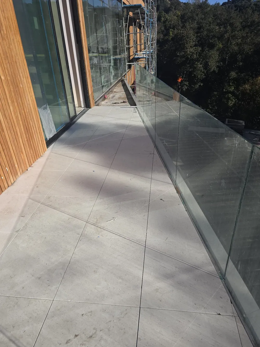 Glass balcony railing on a coastal condominium, installed by Versa Glass Co.