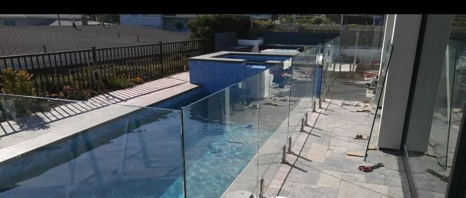 Frameless glass fence along a lap pool in Los Angeles