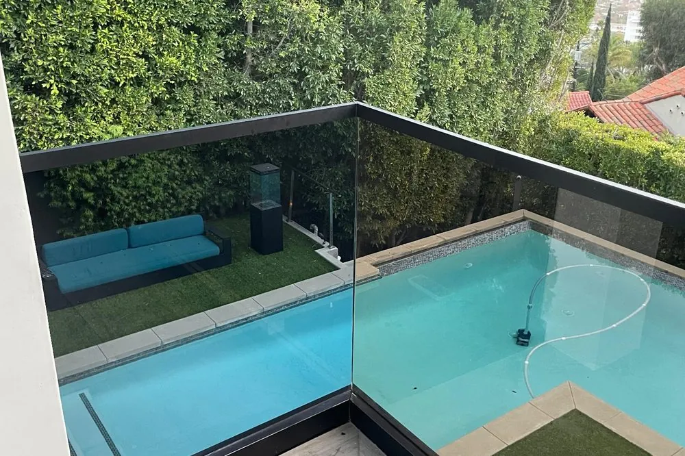 Frameless glass pool fence with city views