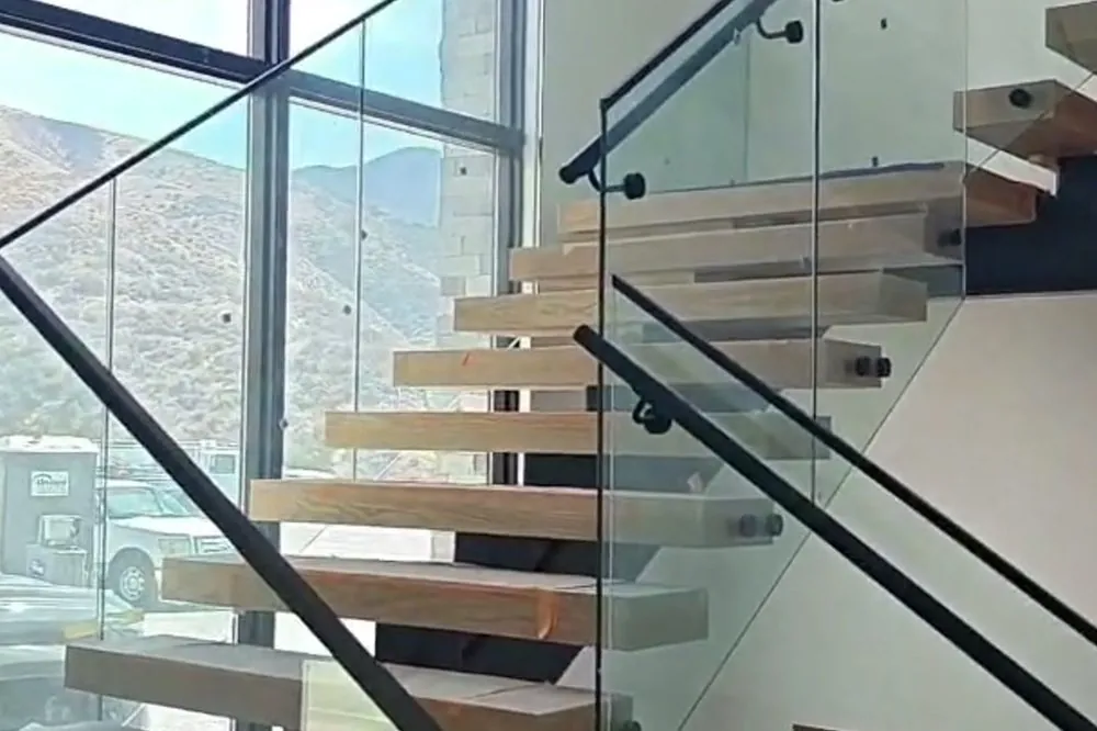 Frameless glass railing on a floating staircase