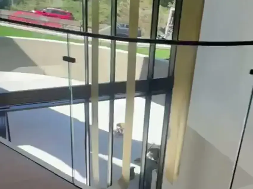 Curved frameless glass balcony railing in Los Angeles