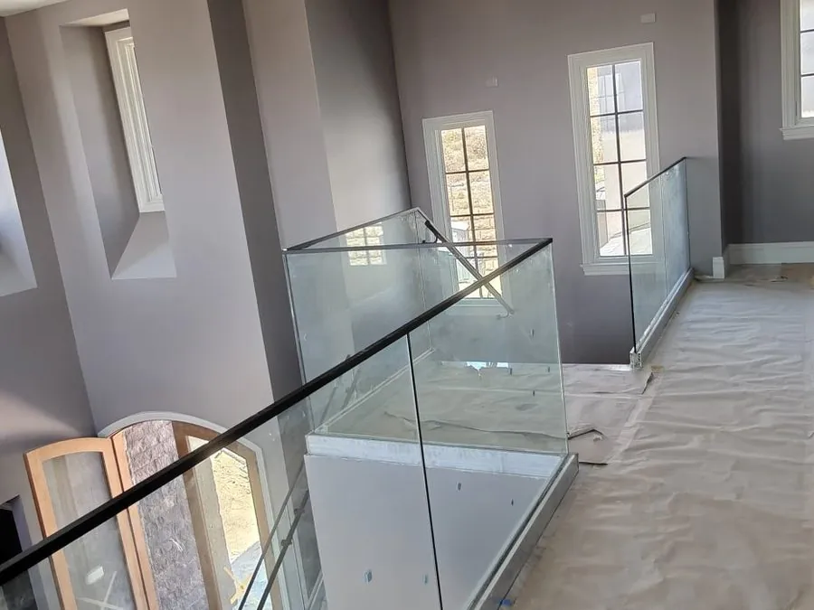 Standoff-mounted glass railing along an upper hallway, Los Angeles
