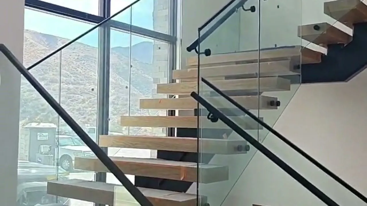 Frameless glass railing on a floating staircase in a Los Angeles home, installed by Versa Glass Co.