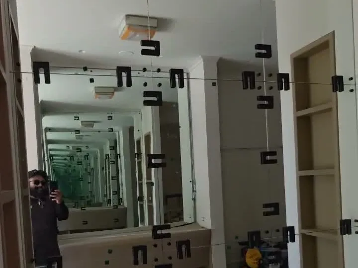 Custom mirror wall being installed by Versa Glass Co.