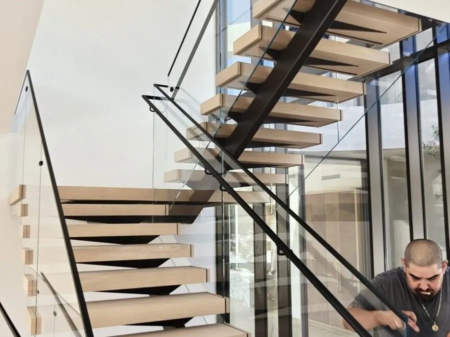 Frameless glass staircase railing installed by Versa Glass Co.